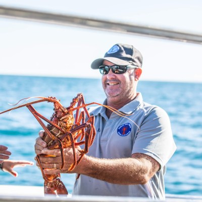 a man standing next to a body of water