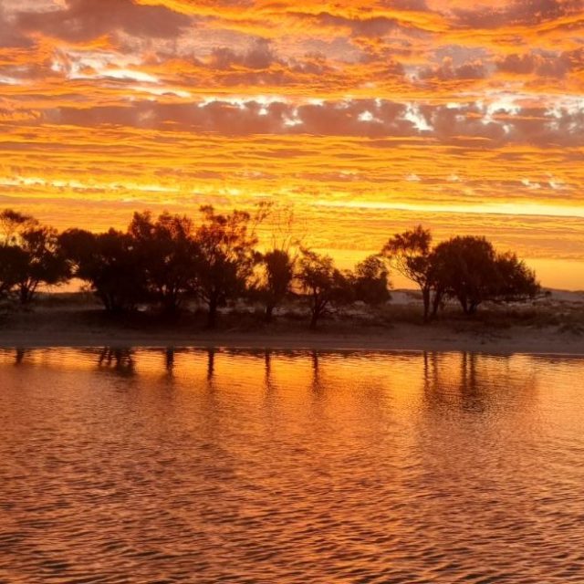 a sunset over a body of water